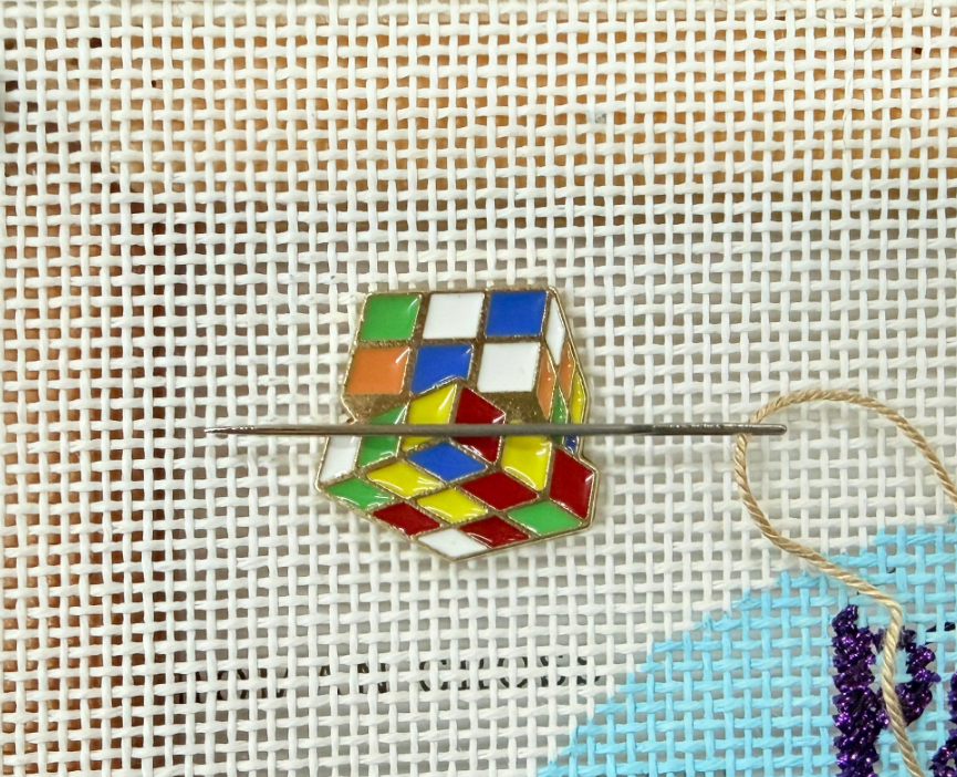 Colorful rotating cube - needle minder